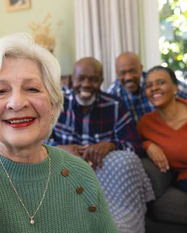 Happy caucasian senior woman doing selfie and smiling in sunny living room, copy space. Retirement, domestic life and senior lifestyle, communication, technology, unaltered.